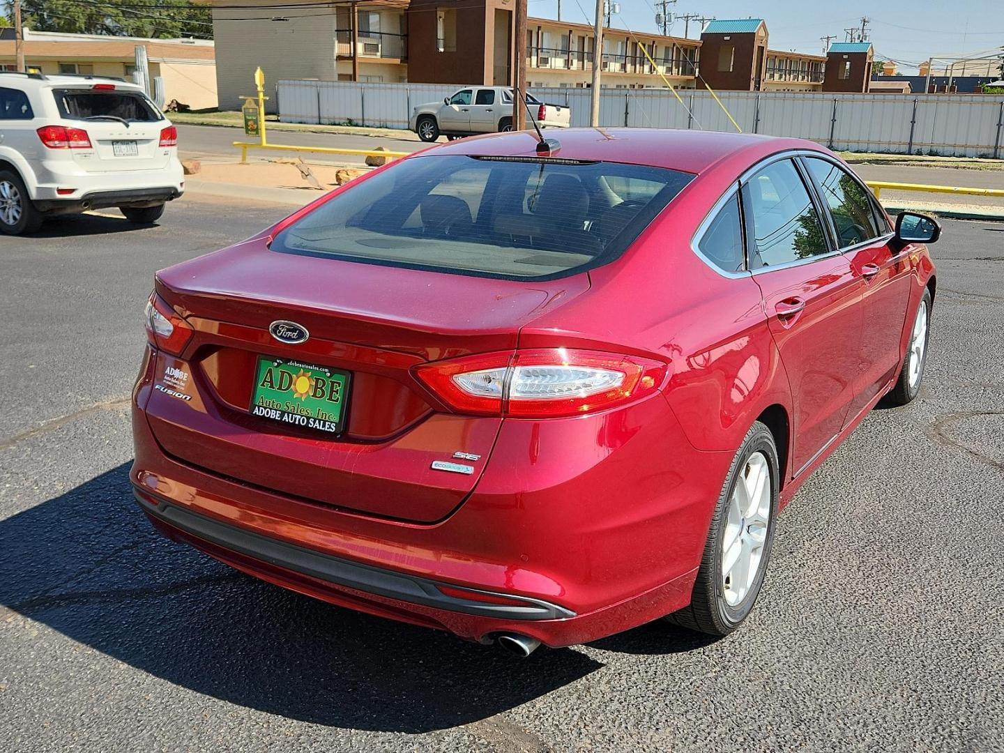 2016 Ruby Red Metallic Tinted Clearcoat /Charcoal Black, cloth Ford Fusion SE (3FA6P0HD3GR) with an ENGINE: 1.5L ECOBOOST engine, located at 4711 Ave Q, Lubbock, TX, 79412, (806) 687-2362, 33.551304, -101.855293 - Photo#3